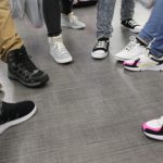 Students pose with their new shoes